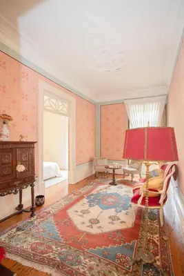a hallway with white doors and wood floors at Palace Museum & National Monument - Espaço Palmeiras in Porto