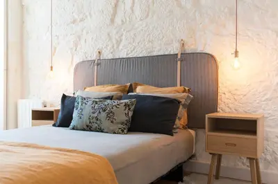a bed with pillows on it in a bedroom at Cativo Apartment - Porto Downtown in Porto