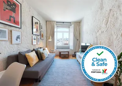 a living room with a couch and a table at Cativo Apartment - Porto Downtown in Porto