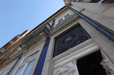 a building with a door with a clock on it at FLH Living Oporto Lofts in Porto