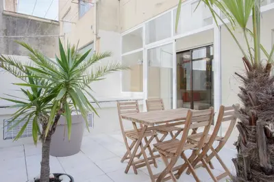 a white kitchen with a refrigerator and white cabinets at Liiiving in Porto - Terrace Downtown Apartment in Porto