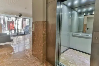 a glass door in a lobby with a window at Aspasios Picaria Apartments in Porto