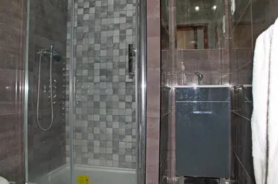 a bathroom with a shower with a glass door at D. Duarte I in Porto