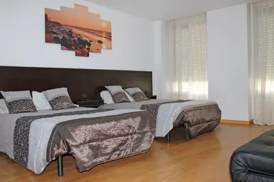 a bedroom with two beds and a couch at D. Duarte I in Porto