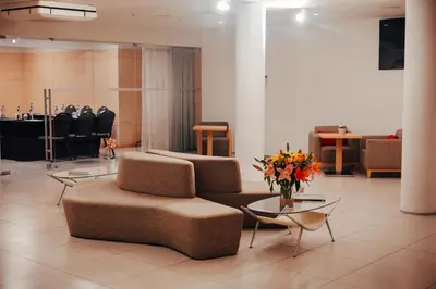 a room with rows of tables and chairs in it at Hotel da Música in Porto