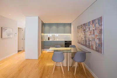 a kitchen with a table and chairs and a counter at PipaD'oro by YoursPorto in Porto