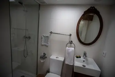 a bathroom with a toilet and a sink and a shower at Domus Duorum in Porto