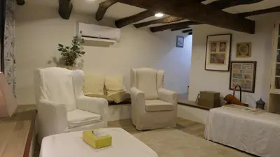 a living room with two white chairs and a couch at Domus Duorum in Porto
