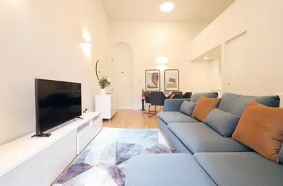 a living room with a couch and a flat screen tv at HM - Oporto Cedofeita 500C in Porto