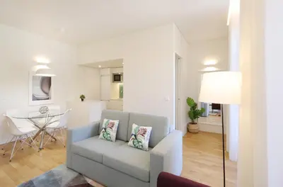 a living room with a couch and a table at HM - Oporto Cedofeita 500E in Porto