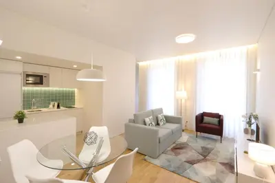 a kitchen and living room with a glass table and chairs at HM - Oporto Cedofeita 500E in Porto