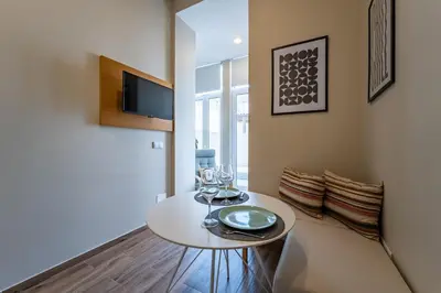 a dining room with a white table and chairs at Nomad's Boulevard Bonfim Porto in Porto