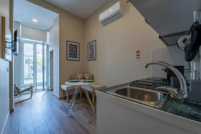 a kitchen with a sink and a counter top at Nomad's Boulevard Bonfim Porto in Porto