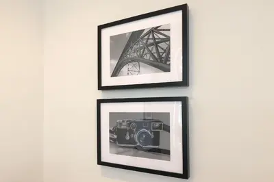 two framed pictures of the eiffel tower on a wall at FLH Sá da Bandeira Luxury Apartment in Porto