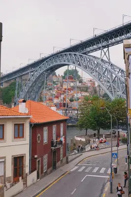 a bridge over a river with buildings and a street at Portobello Lux Living in Vila Nova de Gaia