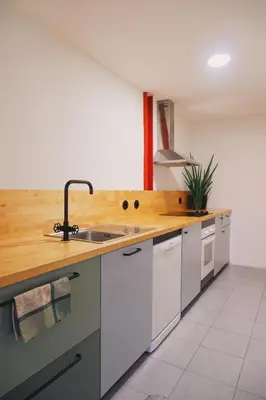 a kitchen with a sink and a wooden counter top at Portobello Lux Living in Vila Nova de Gaia