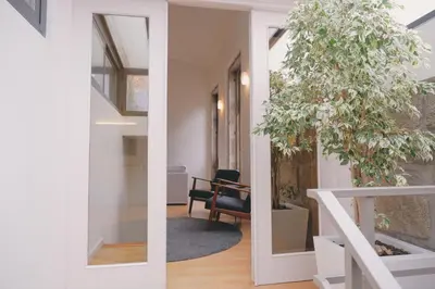 a pivot door in a house with a plant at Portobello Lux Living in Vila Nova de Gaia
