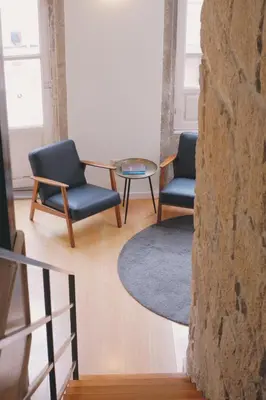 two chairs and a table in a room at Portobello Lux Living in Vila Nova de Gaia