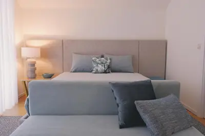 a bedroom with a large bed and a couch at Portobello Lux Living in Vila Nova de Gaia
