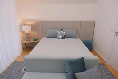 a bedroom with a large bed and a couch at Portobello Lux Living in Vila Nova de Gaia