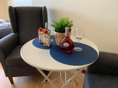 a white table with a bottle of wine and a glass at Invicta House Loft Boavista in Porto