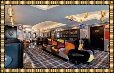 a bar with couches and chairs in a room at Hotel Jaguar Oporto - is Near the Metro has Free Parking and a Free Shuttle Service between the Airport and the Hotel from 7AM to 8PM in Porto