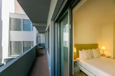 a bedroom with a bed and a hallway with a window at Casa São Lázaro- Terrace by Oporto Soul in Porto