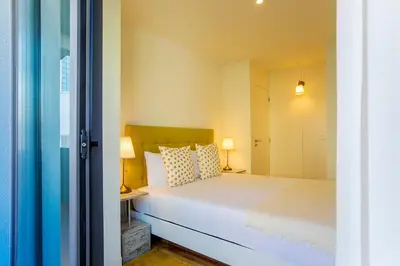 a bedroom with a white bed and two lamps at Casa São Lázaro- Terrace by Oporto Soul in Porto