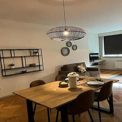 a living room with a wooden table and a couch at bnapartments Trindade in Porto