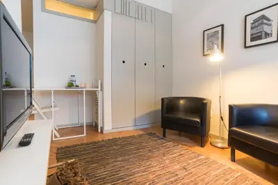 a living room with a couch and a chair at bnapartments Trindade in Porto
