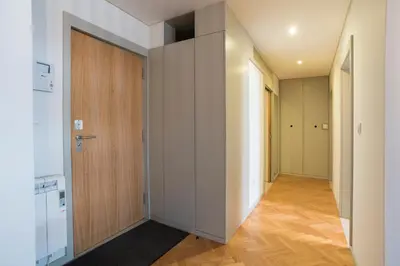 an empty hallway with a wooden door and a room at bnapartments Trindade in Porto