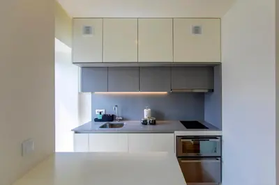 a kitchen with white cabinets and a sink at Casa São Lázaro by Oporto Soul in Porto