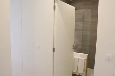 a white cabinet in a bathroom with a towel at Casa São Lázaro by Oporto Soul in Porto