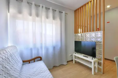 a closet with wooden cabinets in a room at Jardim do Pilar T1 in Vila Nova de Gaia