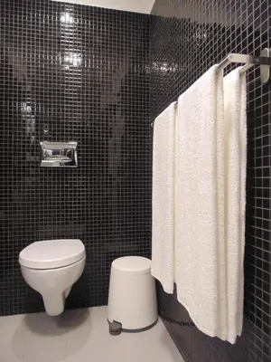 a bathroom with a toilet and white towels at Dream Modern House in Porto