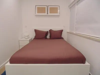 a bed in a white room with a window at Dream Modern House in Porto