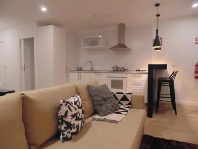 a living room with a couch and a kitchen at Dream Modern House in Porto