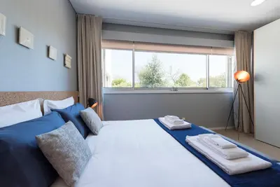 a bedroom with a large bed with towels on it at CN150 boutique studio, charming flat in Porto