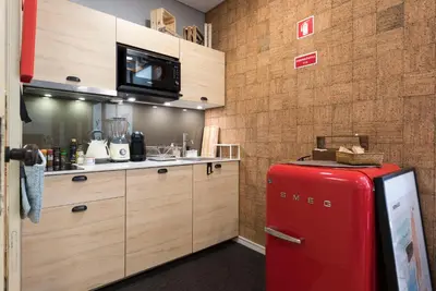 a kitchen with a red refrigerator in a room at CN150 boutique studio, charming flat in Porto