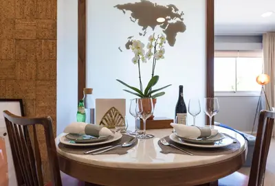 a dining room table with a vase of flowers on it at CN150 boutique studio, charming flat in Porto
