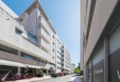 an empty street with buildings and tables and chairs at CN150 boutique studio, charming flat in Porto