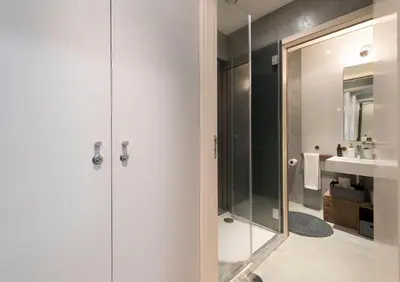 a bathroom with a glass shower and a sink at CN150 boutique studio, charming flat in Porto