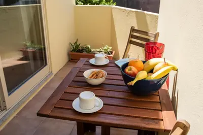 a table with a bowl of fruit on a balcony at Porto Gaia City House by MP in Vila Nova de Gaia