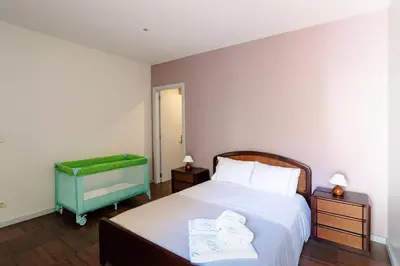 a bedroom with a bed with two towels on it at Porto Gaia City House by MP in Vila Nova de Gaia