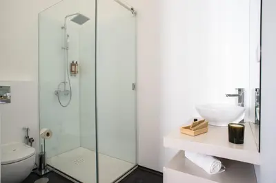 a bathroom with a shower and a toilet and a sink at D'Autor Apartments Alegria in Porto