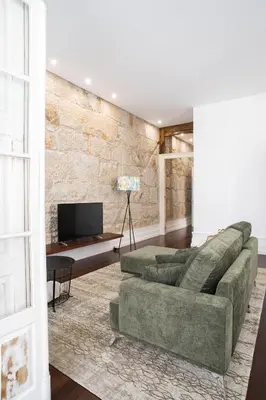 a living room with a couch and a tv at D'Autor Apartments Alegria in Porto
