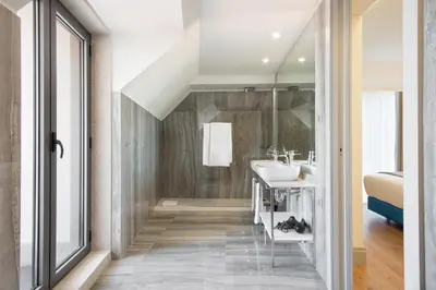 a bathroom with a sink and a mirror at Acta The Avenue in Porto
