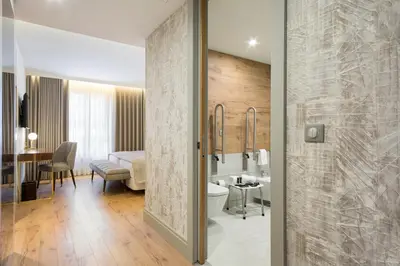 a bathroom with a sink and a toilet in a room at Acta The Avenue in Porto
