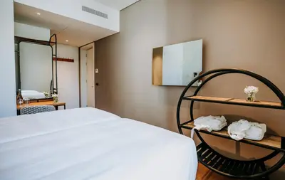 a shelf with white shoes on it with a vase of flowers at Exmo Hotel by Olivia in Porto