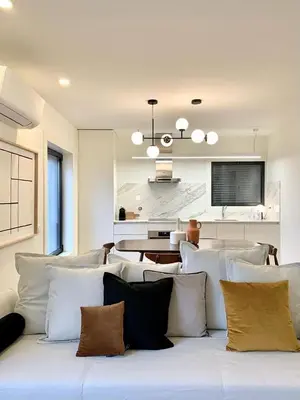 a living room with a white couch with pillows at Oporto Chic&Cozy - Batalha II in Porto